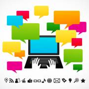 لپ تاپ و باکس های رنگی باز شده روی آن